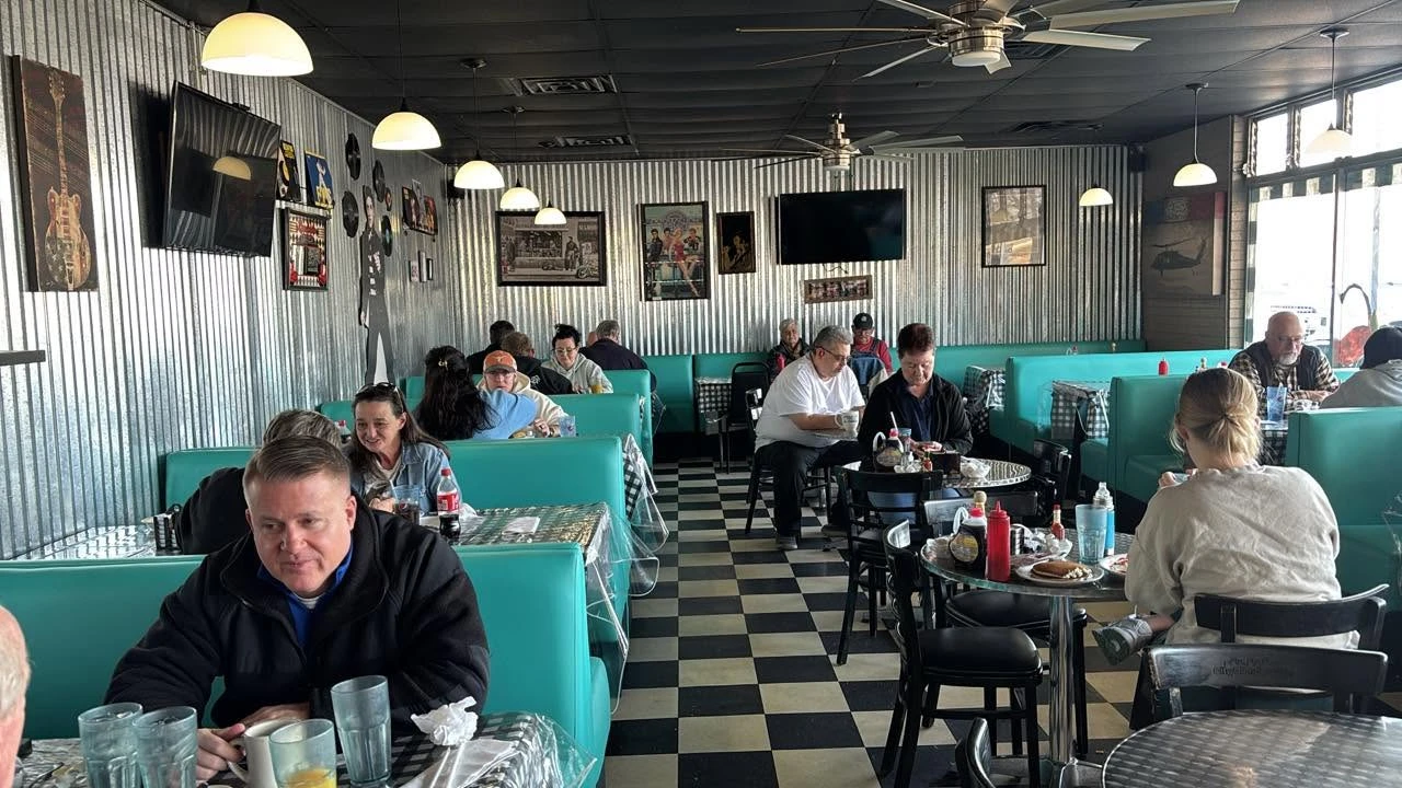 Inside Lizzy's Diner — turquoise booths and a black-and-white checkered floor