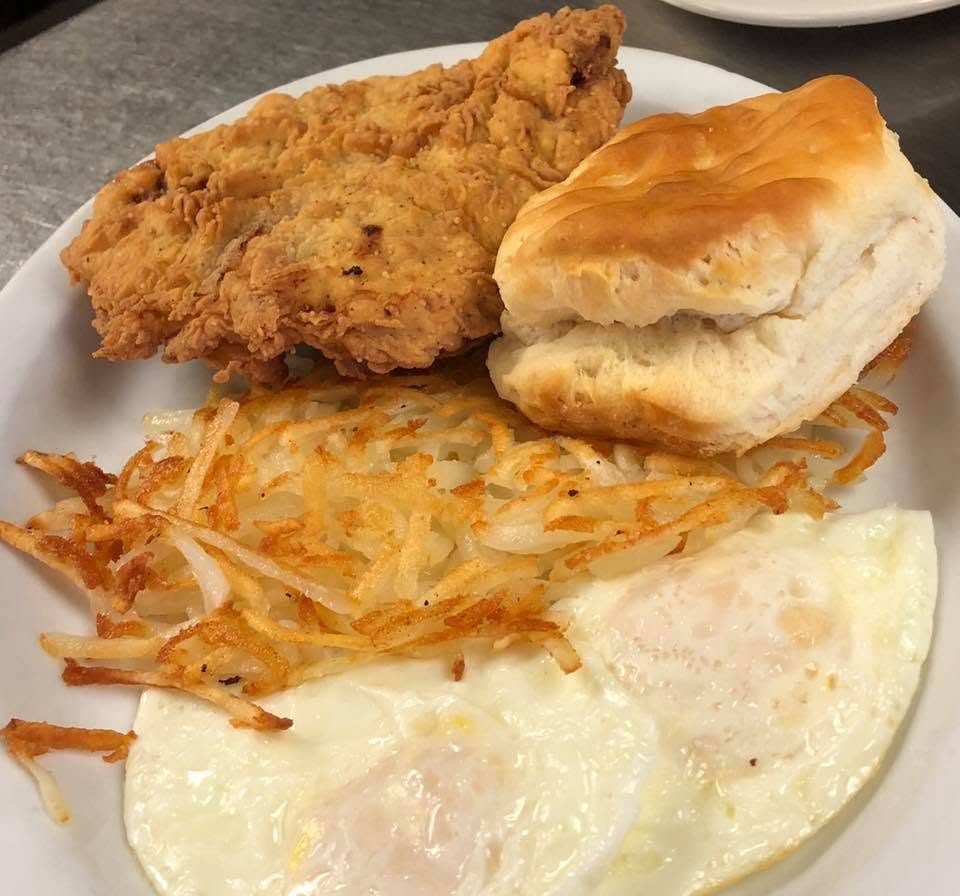 Chicken-fried steak with a fluffy biscuit, crispy hash browns, and eggs