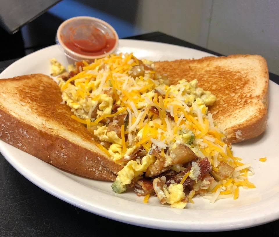 The loaded Hobo Scramble topped with melted cheese, with Texas toast